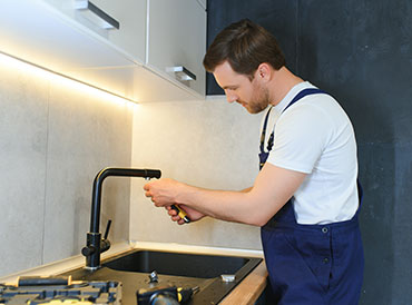 Licensed plumber installing a new water tap during professional plumbing service in Gauteng