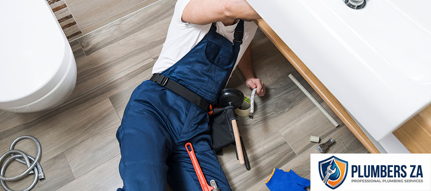 Plumber performing plumbing inspection to check pipes and water systems in Gauteng