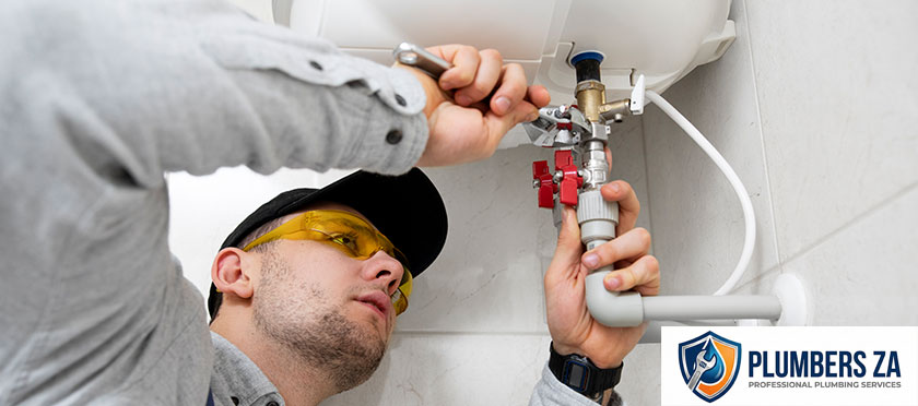 Plumber repairing a geyser water heater to restore hot water supply in Gauteng